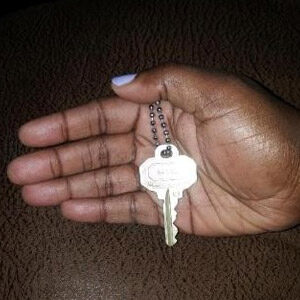 A person holding keys in their hand.